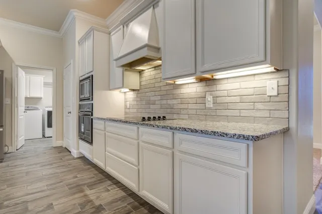 a kitchen with stainless steel appliances granite countertop a sink and cabinets