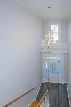 a view of an empty room and wooden floor
