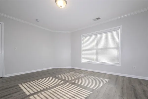 a view of an empty room and wooden floor