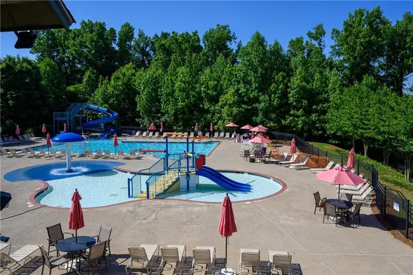 an aerial view of a residential houses with yard