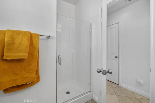 a bathroom with a glass shower door