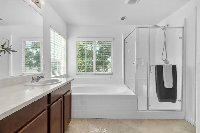 a bathroom with a tub sink and mirror