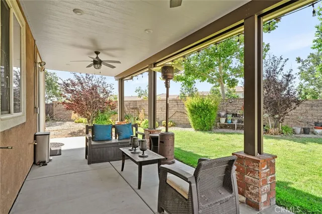 a living room with patio furniture and garden