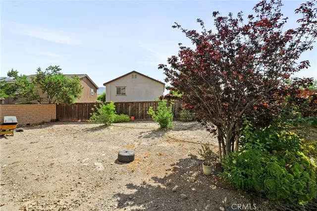 a pathway of a house with a yard