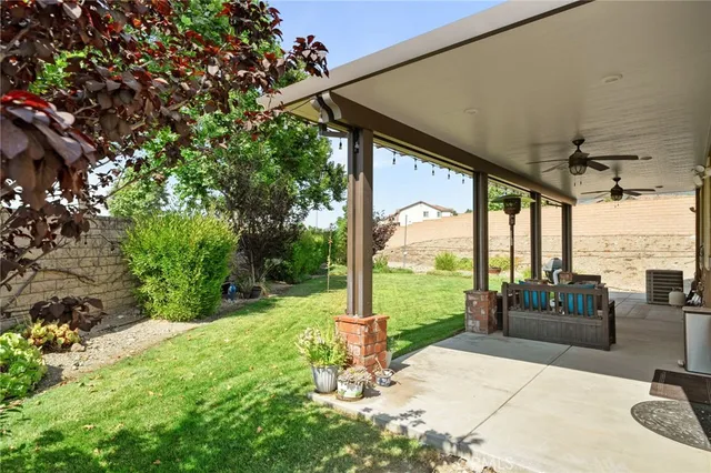 a backyard of a house with fountain table and chairs