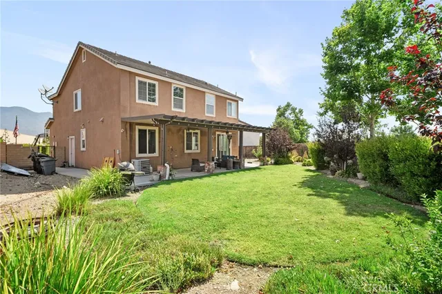 a front view of a house with yard and green space