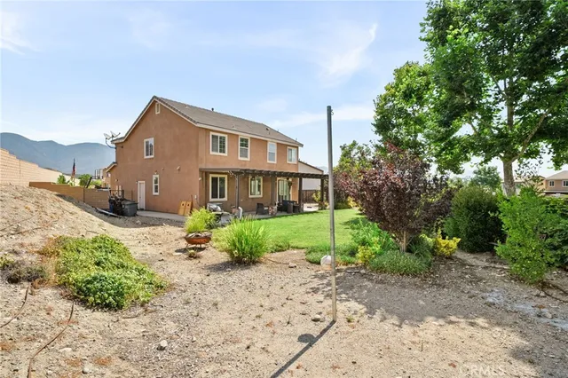 a front view of a house with a yard and trees