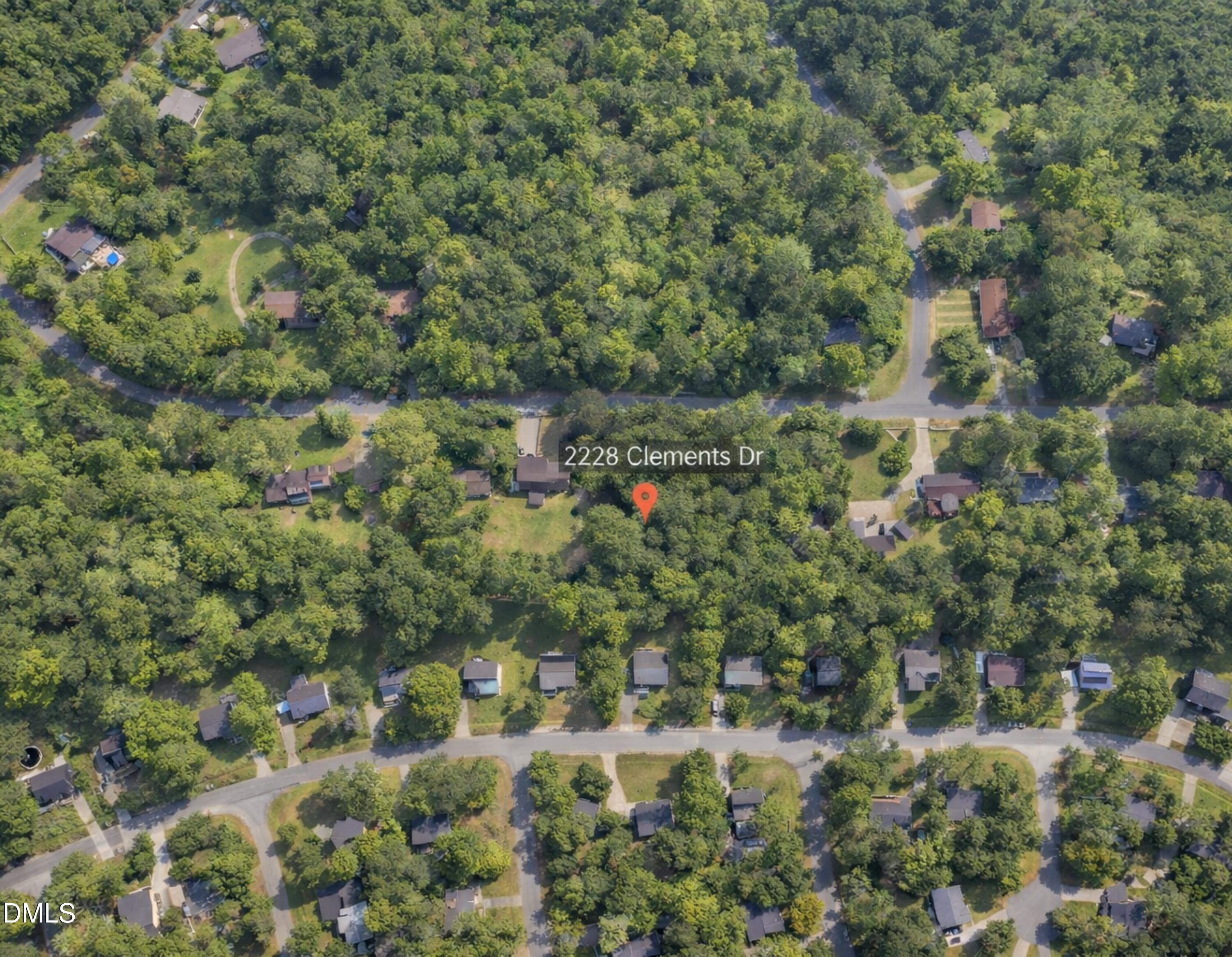2228 Clements Drive Durham, NC 27704 - Photo 2 of 8 a view of a house with a lush green forest