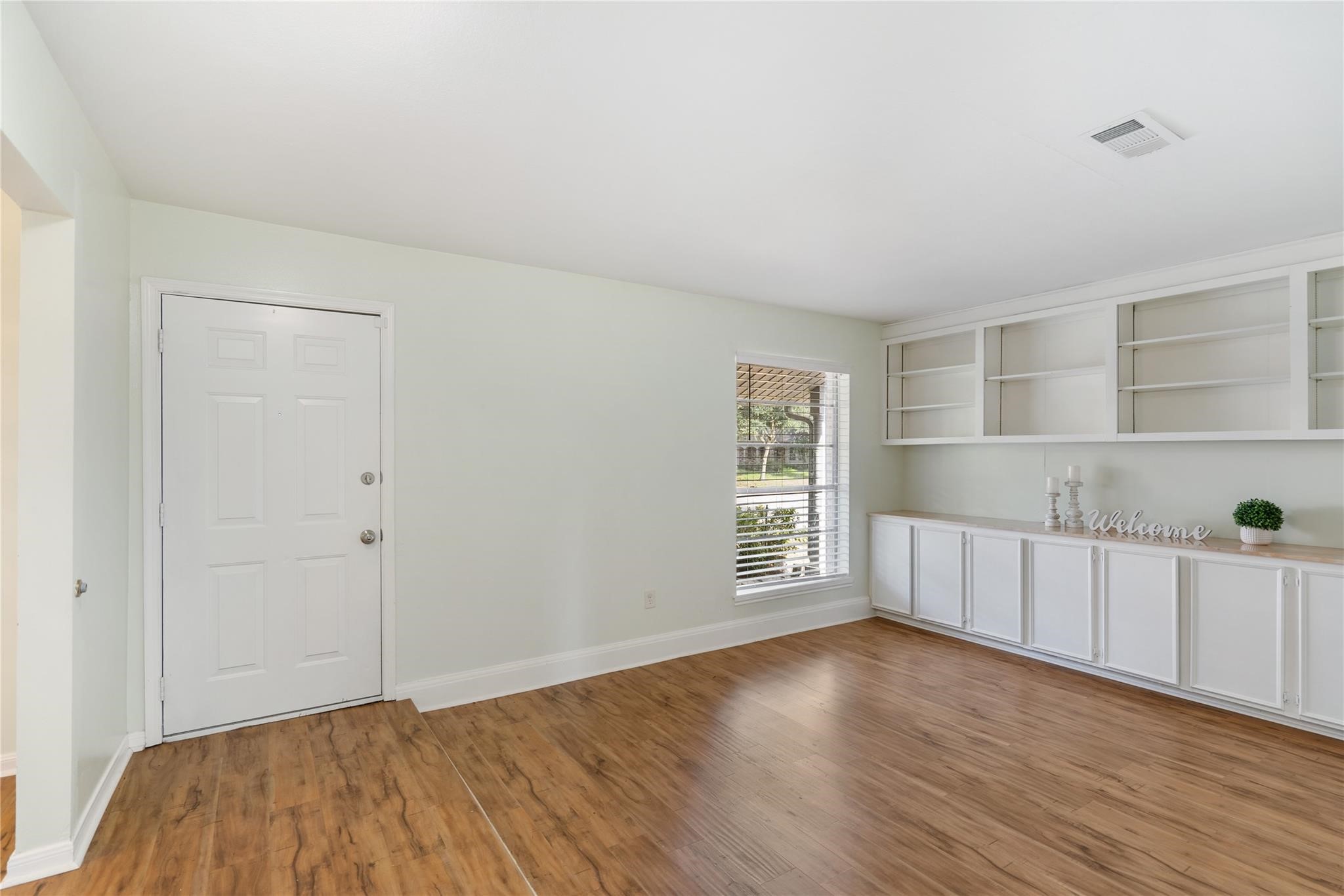 759 Carlingford Lane Houston, TX 77079 - Photo 5 of 16 wooden floor in an empty room with a window