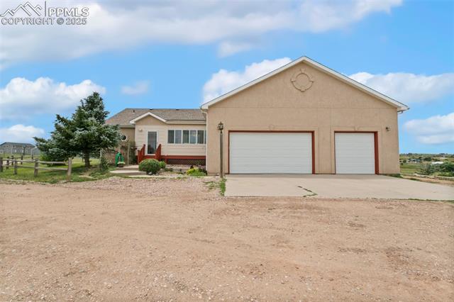13775 Woodlake Road Elbert, CO 80106 - Photo 38 of 44 Single story home with stucco siding, a garage, and driveway