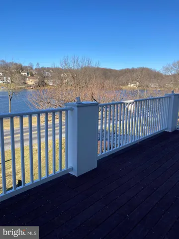 a view of a balcony with wooden floor and city view