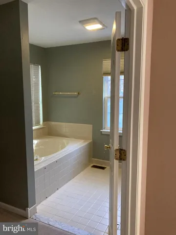 a bathroom with a tub and shower