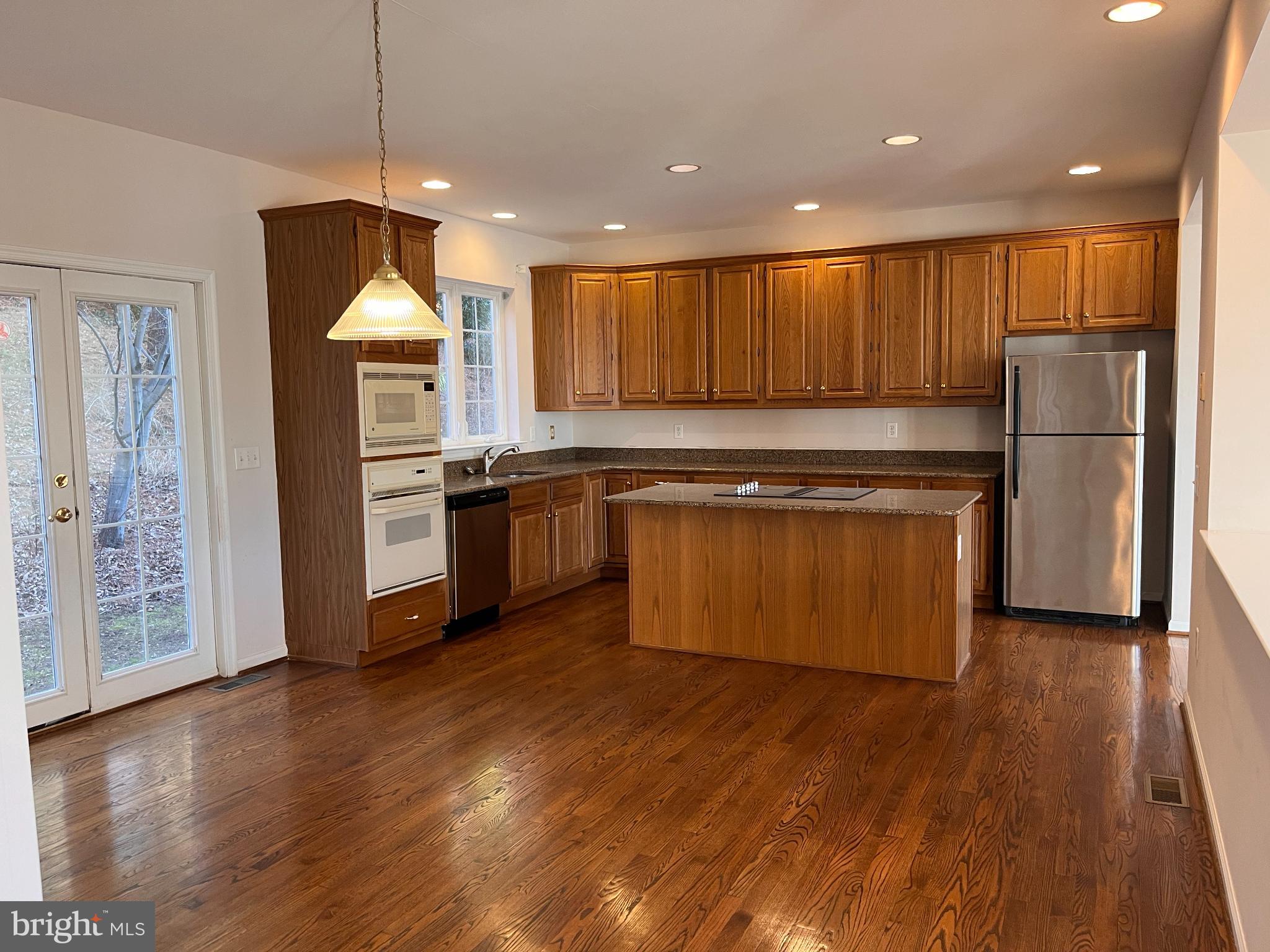 1458 Broad Run Road Landenberg, PA 19350 - Photo 4 of 34 a kitchen with stainless steel appliances granite countertop a refrigerator a sink dishwasher and a stove with wooden floor