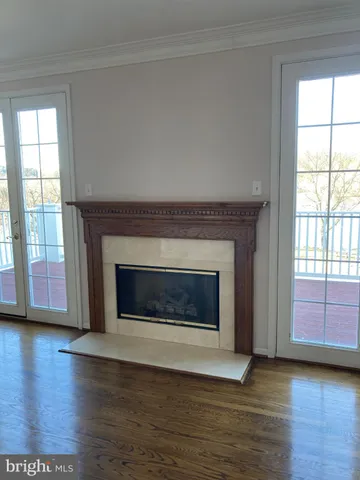 a living room with a fireplace with wooden floor