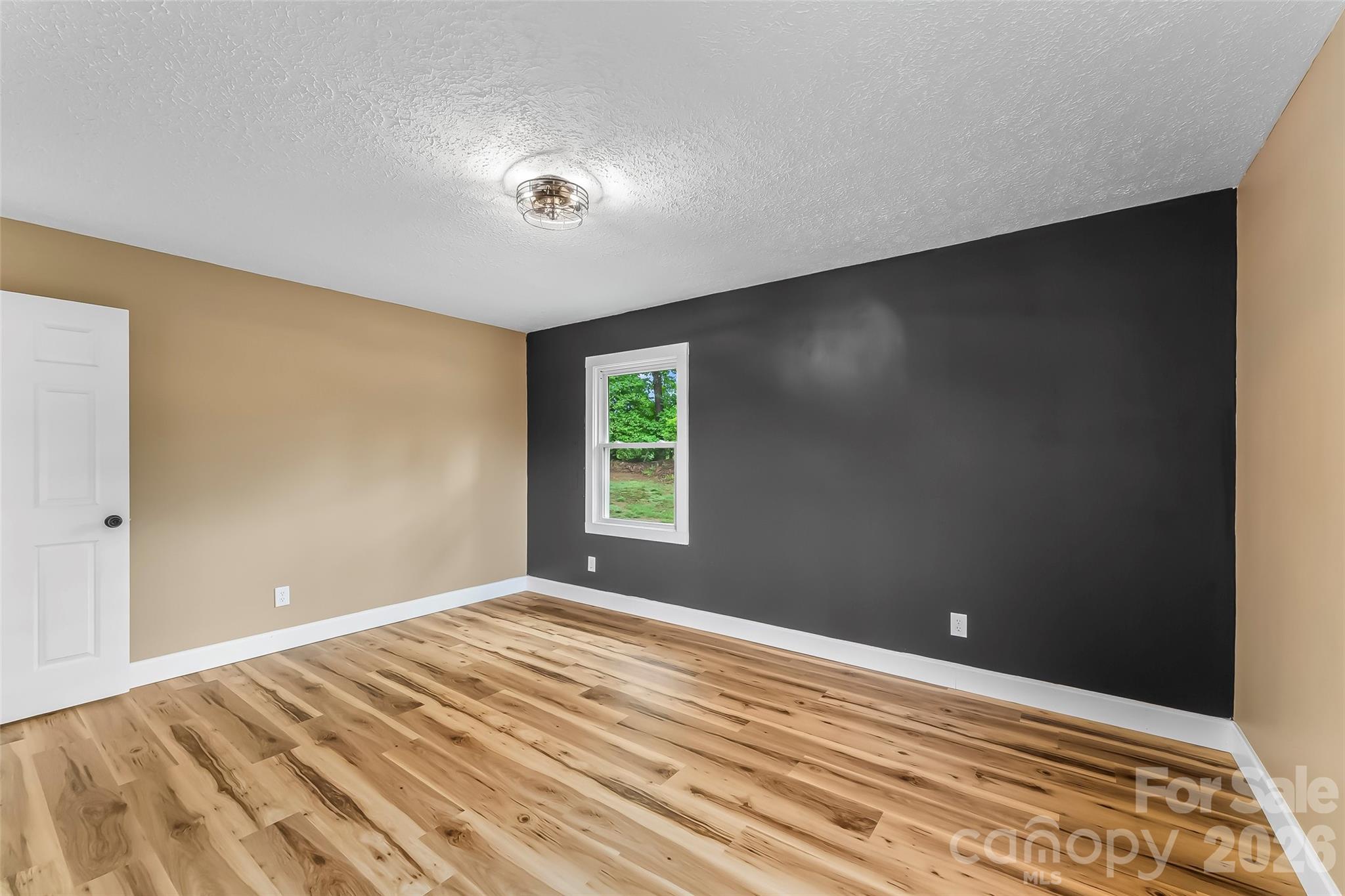 825 South Creek Road Nebo, NC 28761 - Photo 18 of 34 a view of an empty room with wooden floor and a window