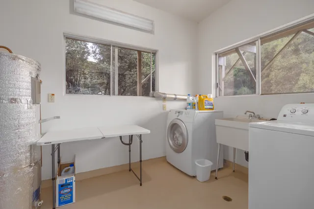 a kitchen with a sink cabinets and wooden floor