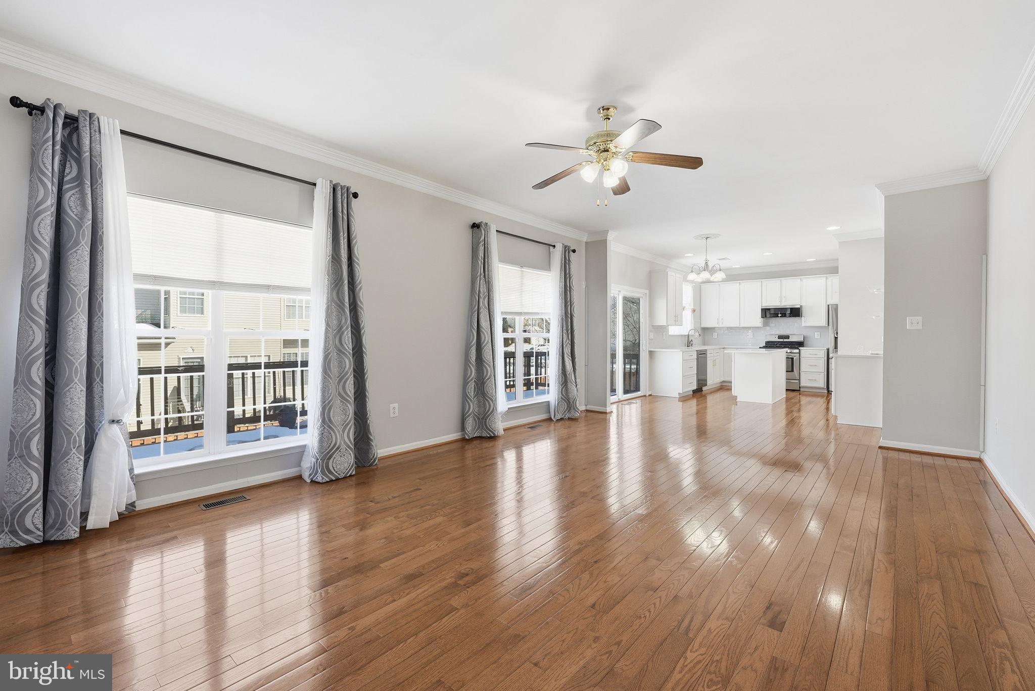 6800 Innesfree Way Gainesville, VA 20155 - Photo 13 of 32 a view of an empty room with wooden floor and a window