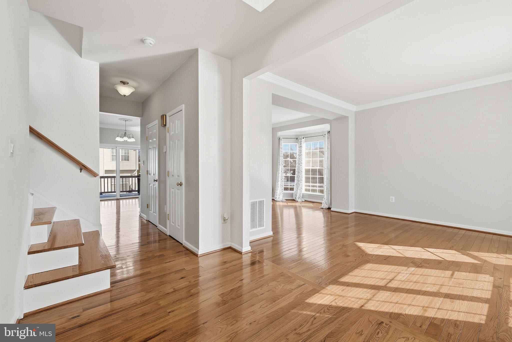6800 Innesfree Way Gainesville, VA 20155 - Photo 14 of 32 a view of an empty room with wooden floor and a window