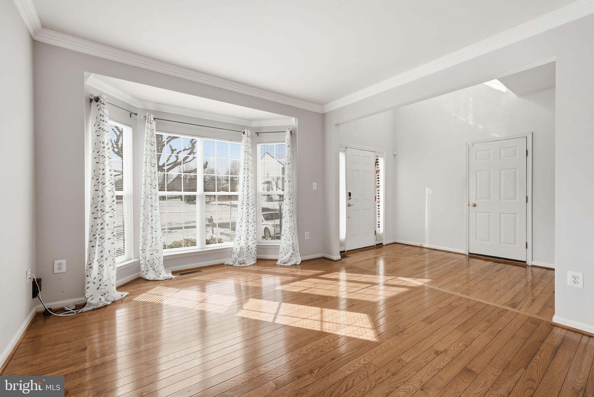 6800 Innesfree Way Gainesville, VA 20155 - Photo 15 of 32 a view of an empty room with wooden floor and a window