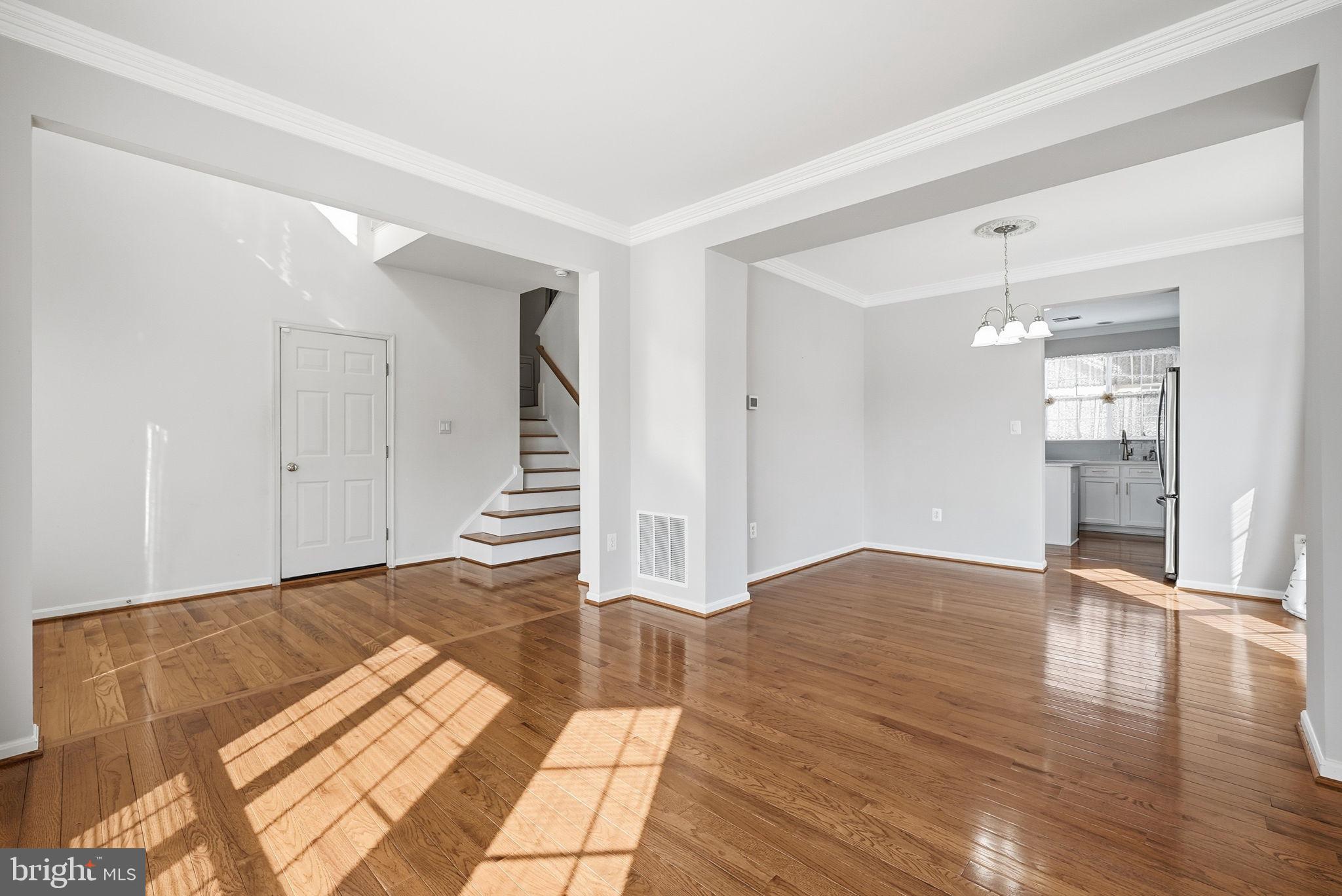 6800 Innesfree Way Gainesville, VA 20155 - Photo 16 of 32 a view of an empty room with wooden floor and staircase