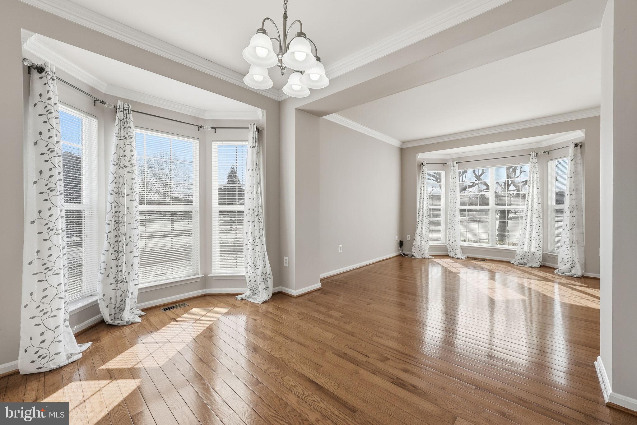 6800 Innesfree Way Gainesville, VA 20155 - Photo 17 of 32 a view of empty room with wooden floor and fan