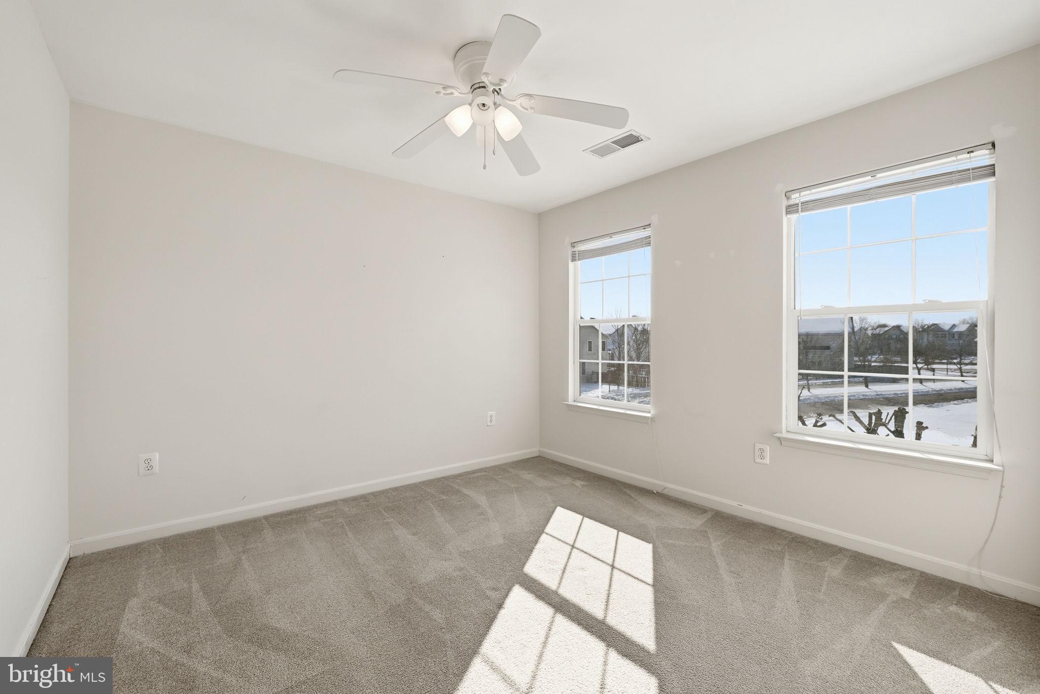 6800 Innesfree Way Gainesville, VA 20155 - Photo 21 of 32 an empty room with windows and ceiling fan