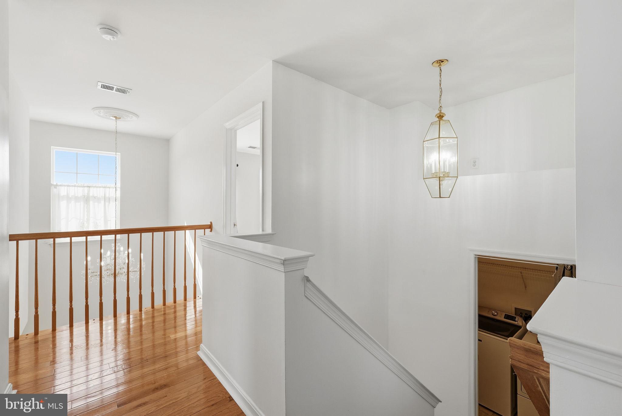 6800 Innesfree Way Gainesville, VA 20155 - Photo 22 of 32 a view of a hallway with closet and wooden floor