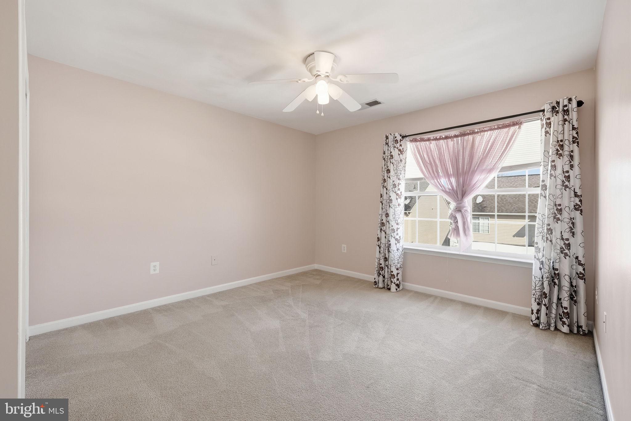 6800 Innesfree Way Gainesville, VA 20155 - Photo 23 of 32 an empty room with windows and chandelier fan