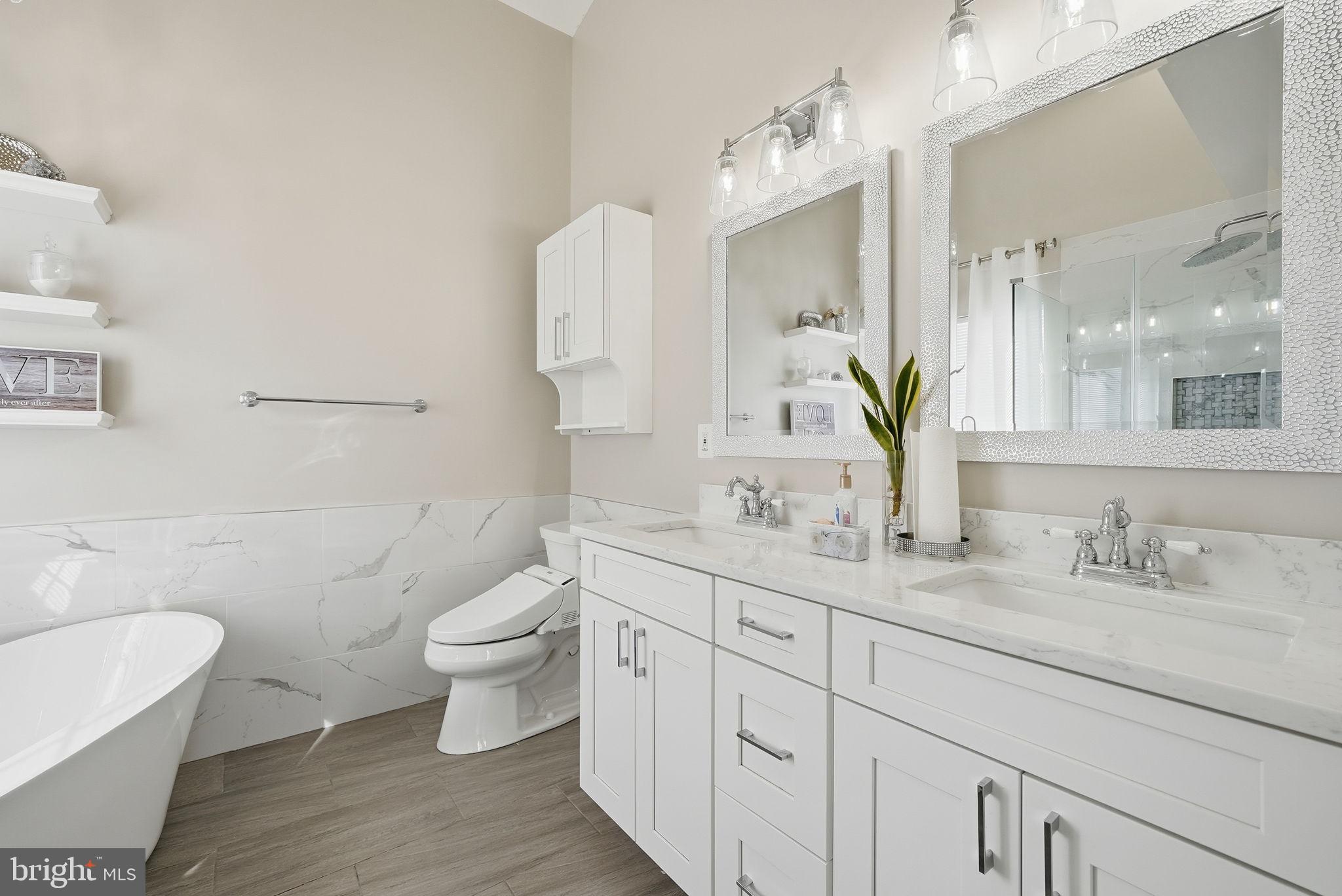 6800 Innesfree Way Gainesville, VA 20155 - Photo 26 of 32 a bathroom with a toilet sink and mirror