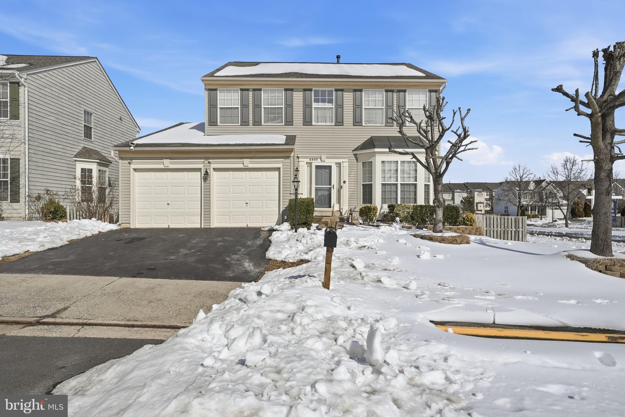 6800 Innesfree Way Gainesville, VA 20155 - Photo 8 of 32 a front view of a house with a yard