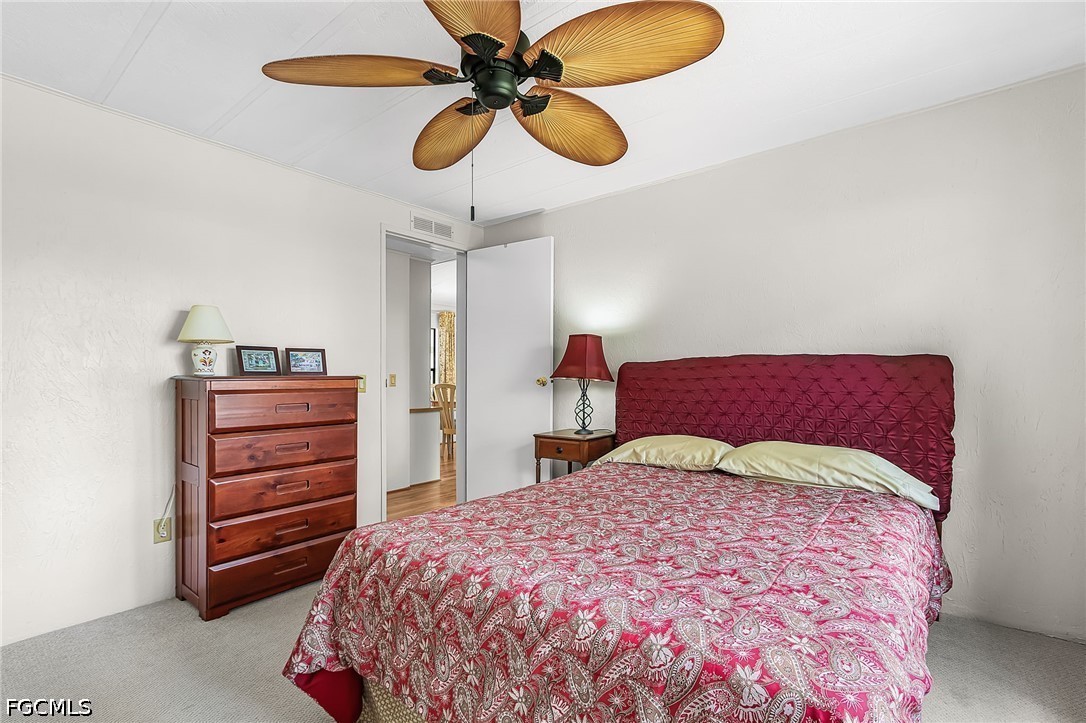 5 Erica Street Alva, FL 33920 - Photo 14 of 37 a bedroom with a bed and a chandelier