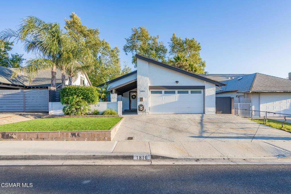 a house with a yard and a large parking space