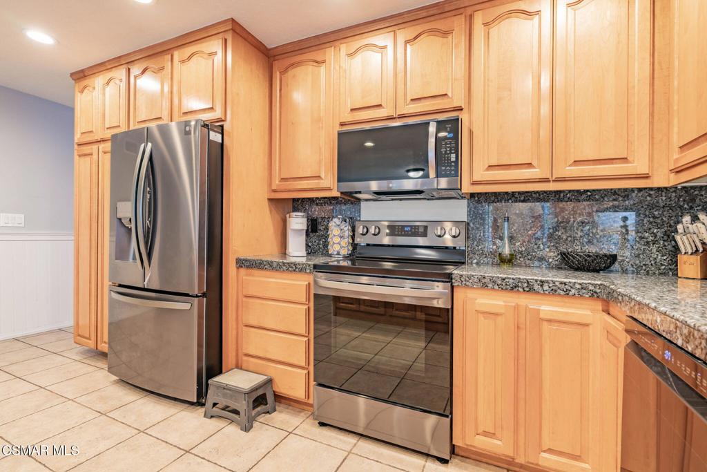1816 Hillary Court Simi Valley, CA 93065 - Photo 19 of 58 a kitchen with stainless steel appliances granite countertop a refrigerator and a stove top oven