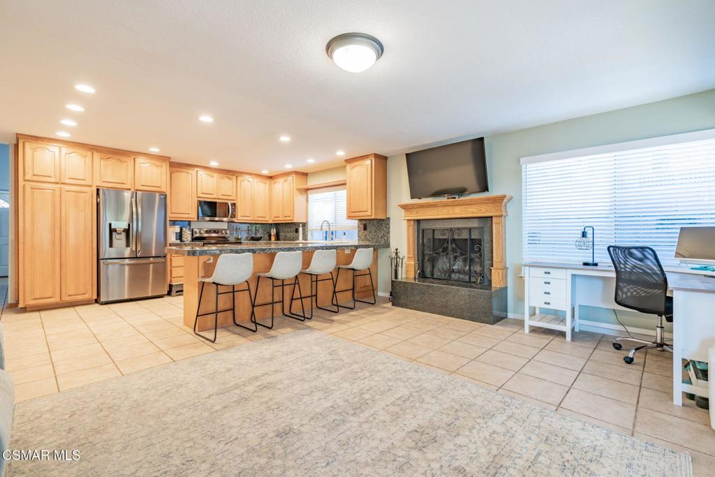 1816 Hillary Court Simi Valley, CA 93065 - Photo 21 of 58 a kitchen with stainless steel appliances kitchen island granite countertop a refrigerator and a stove top oven