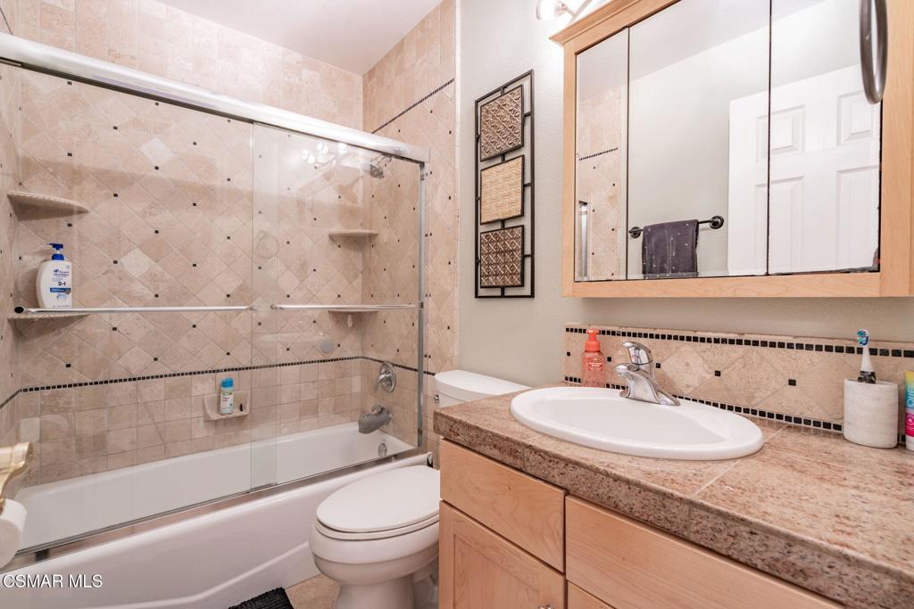 1816 Hillary Court Simi Valley, CA 93065 - Photo 39 of 58 a bathroom with a granite countertop sink a toilet and shower