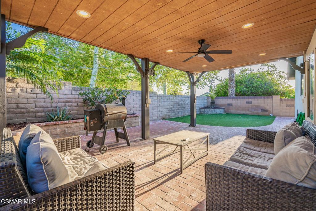 1816 Hillary Court Simi Valley, CA 93065 - Photo 44 of 58 a view of a patio with a dining table and chairs under an umbrella
