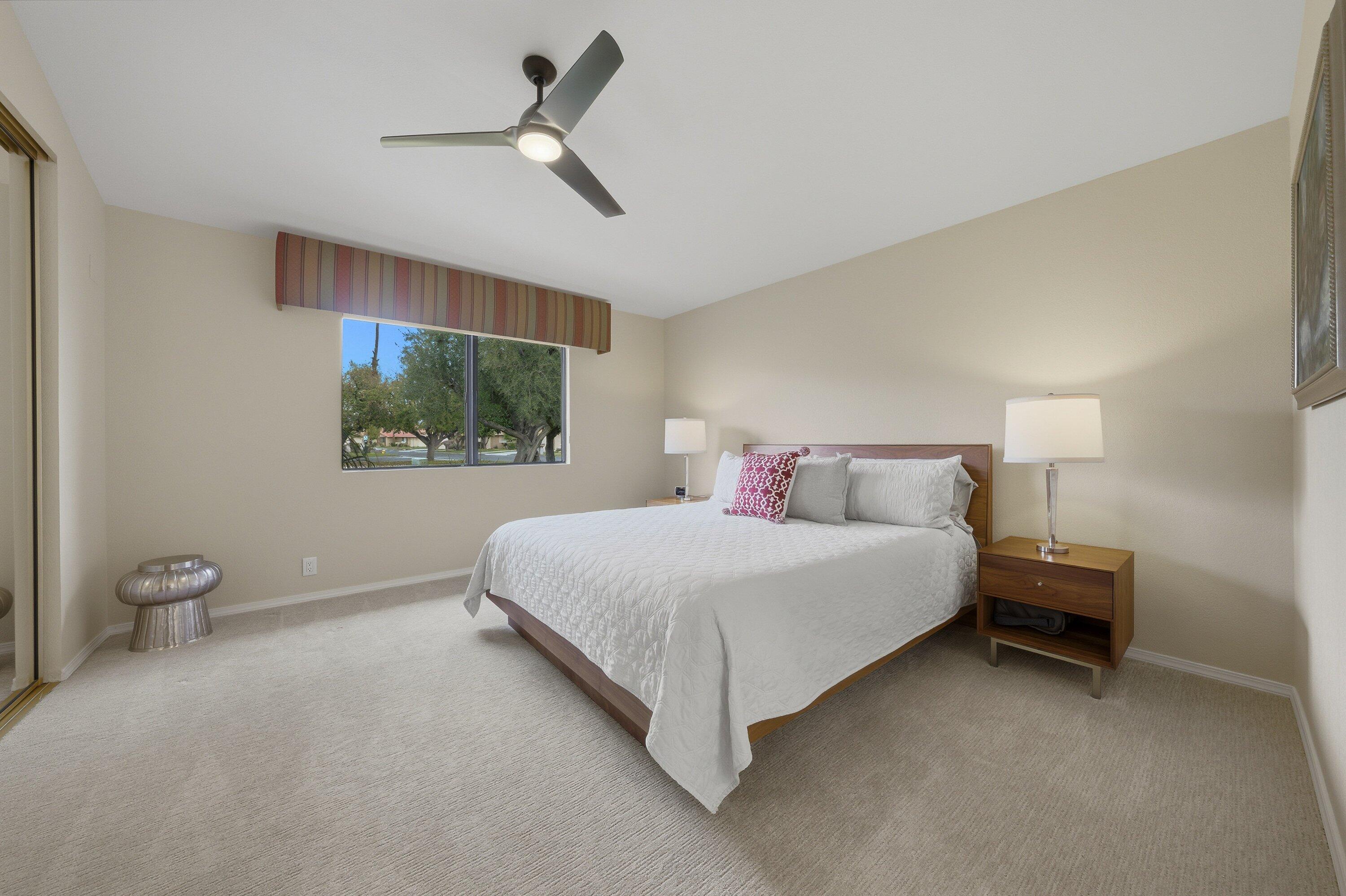 19 Maximo Way Palm Desert, CA 92260 - Photo 16 of 20 a spacious bedroom with a bed and a flat tv screen on the dresser