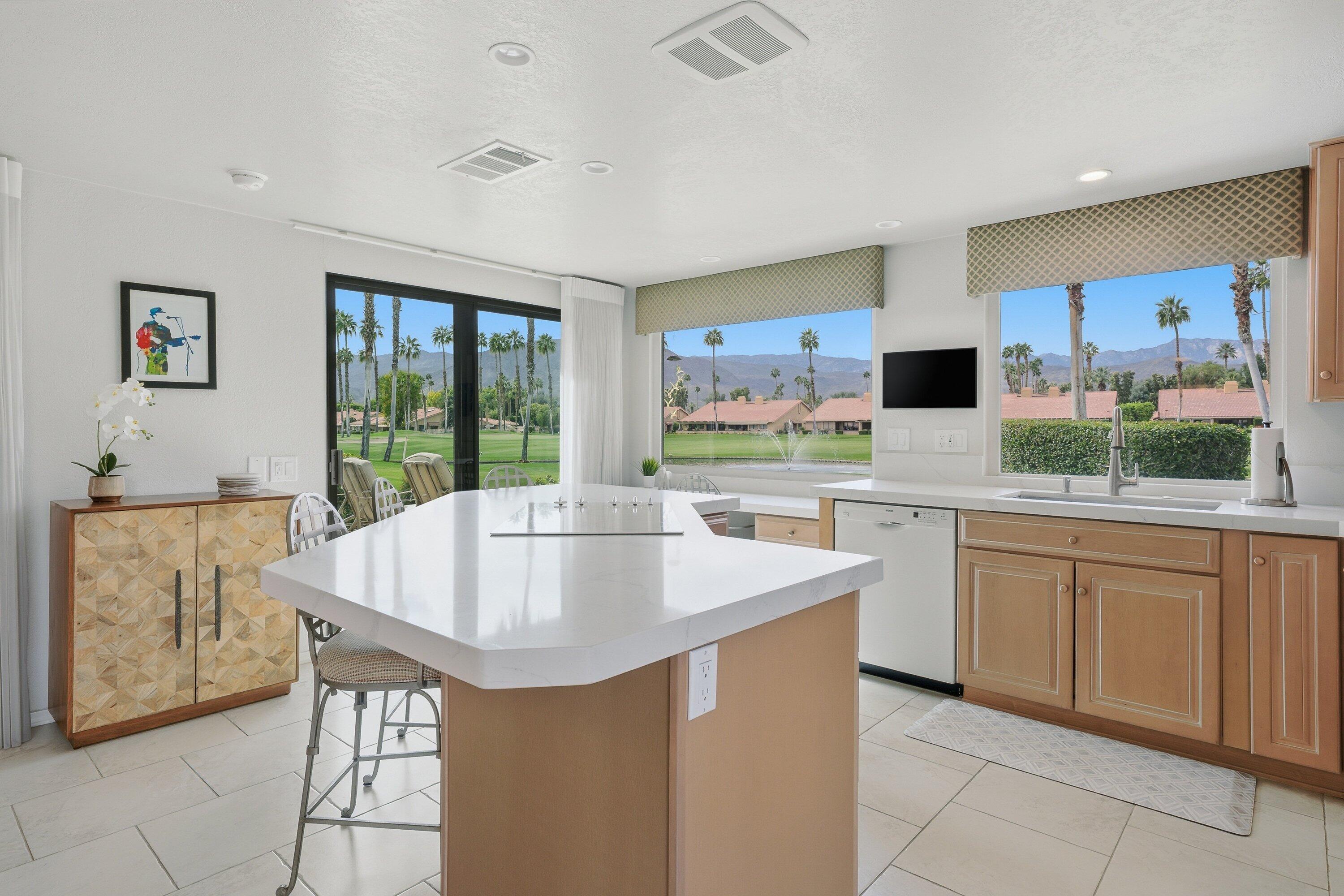 19 Maximo Way Palm Desert, CA 92260 - Photo 10 of 20 a kitchen with stainless steel appliances kitchen island granite countertop a sink and cabinets