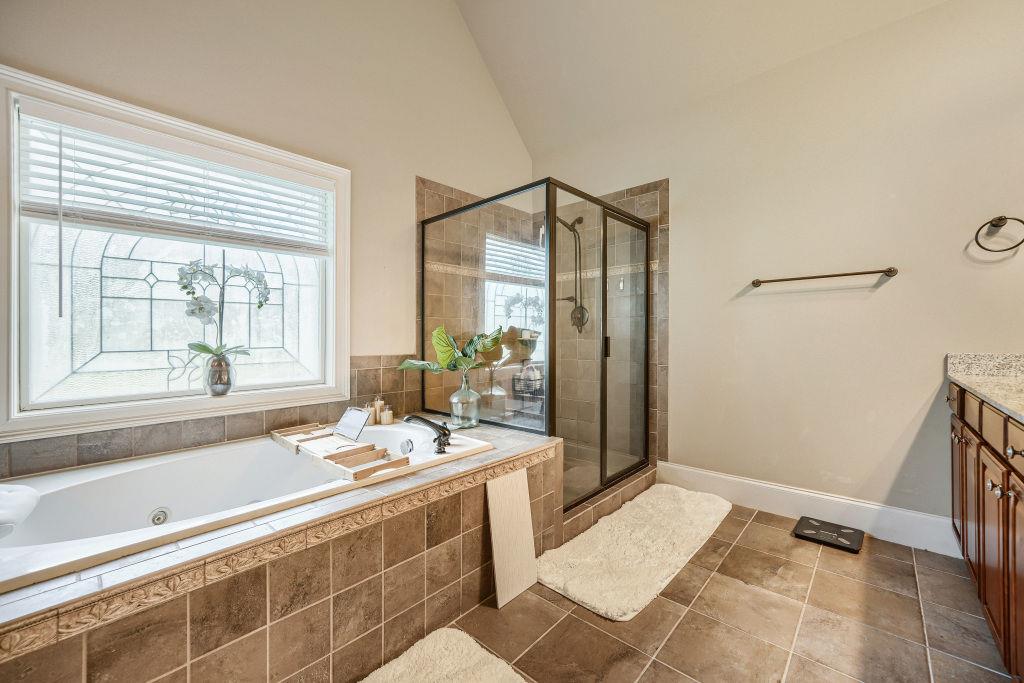 345 Masters Club Boulevard Hampton, GA 30228 - Photo 20 of 30 a bathroom with a tub shower and sink
