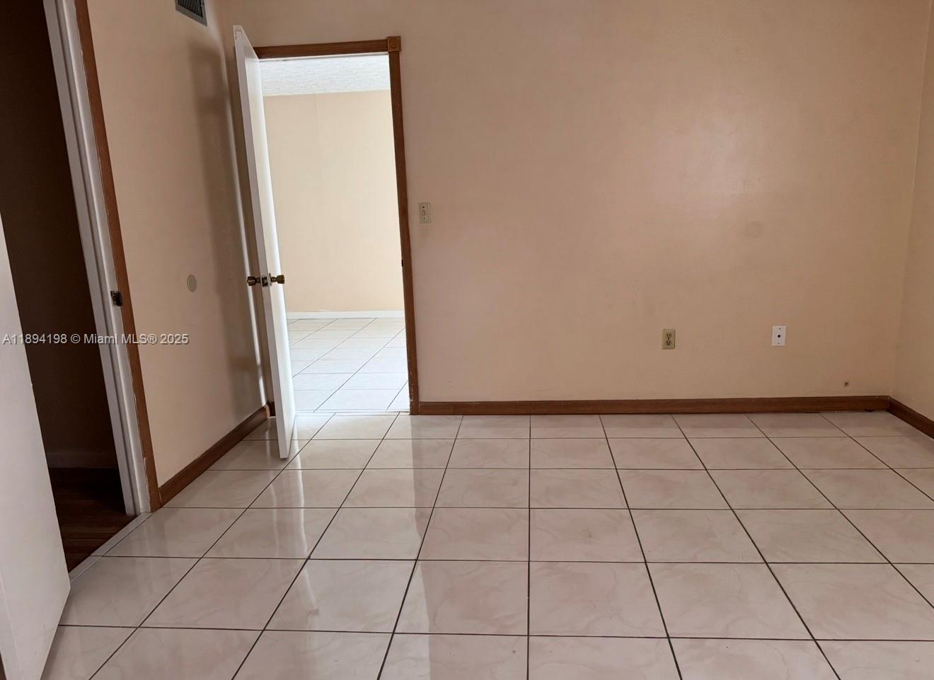 6055 West 19th Avenue, Unit 304 Hialeah, FL 33012 - Photo 16 of 24 an empty room with a bench