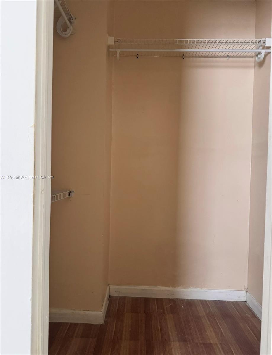 6055 West 19th Avenue, Unit 304 Hialeah, FL 33012 - Photo 18 of 24 a view of a room with wooden floor