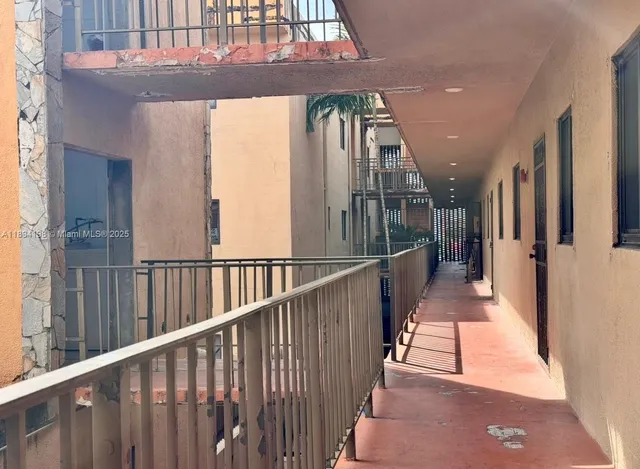 a front view of a multi story residential apartment building with a yard