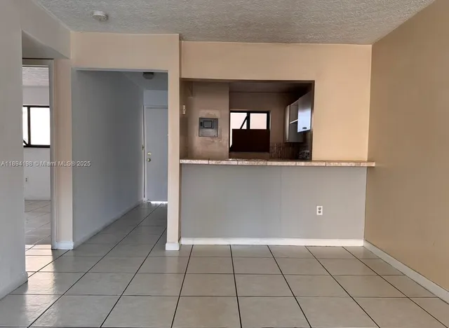 a view of a kitchen cabinets and a living room