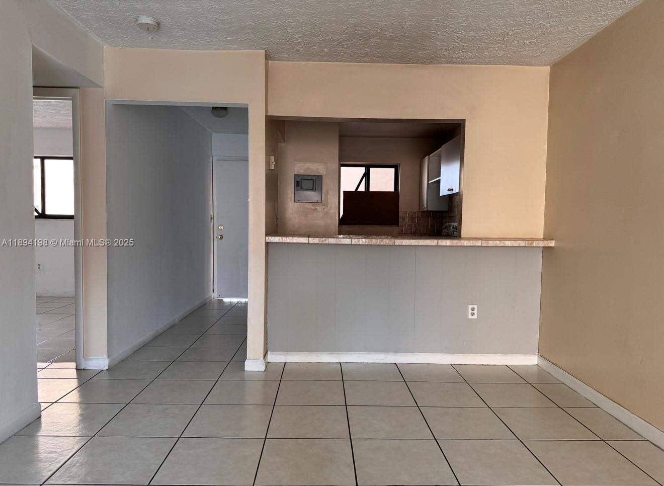 6055 West 19th Avenue, Unit 304 Hialeah, FL 33012 - Photo 4 of 24 a view of a kitchen cabinets and a living room