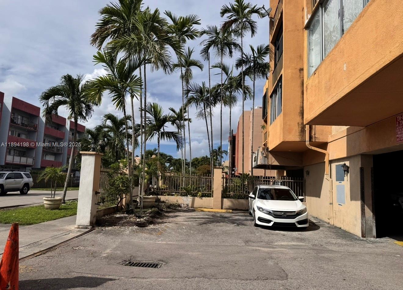 6055 West 19th Avenue, Unit 304 Hialeah, FL 33012 - Photo 6 of 24 a car parked on the side of a street