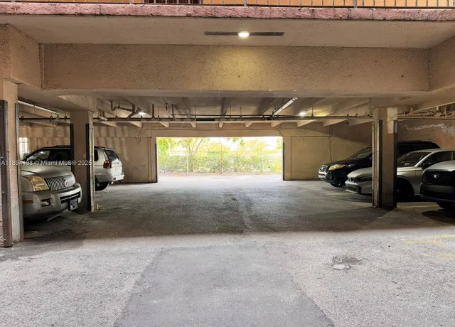 a view of parking garage with cars