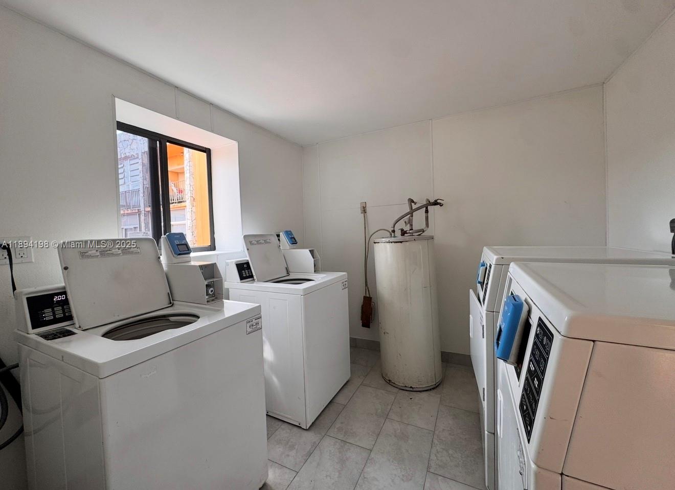 6055 West 19th Avenue, Unit 304 Hialeah, FL 33012 - Photo 9 of 24 a utility room with dryer and washer