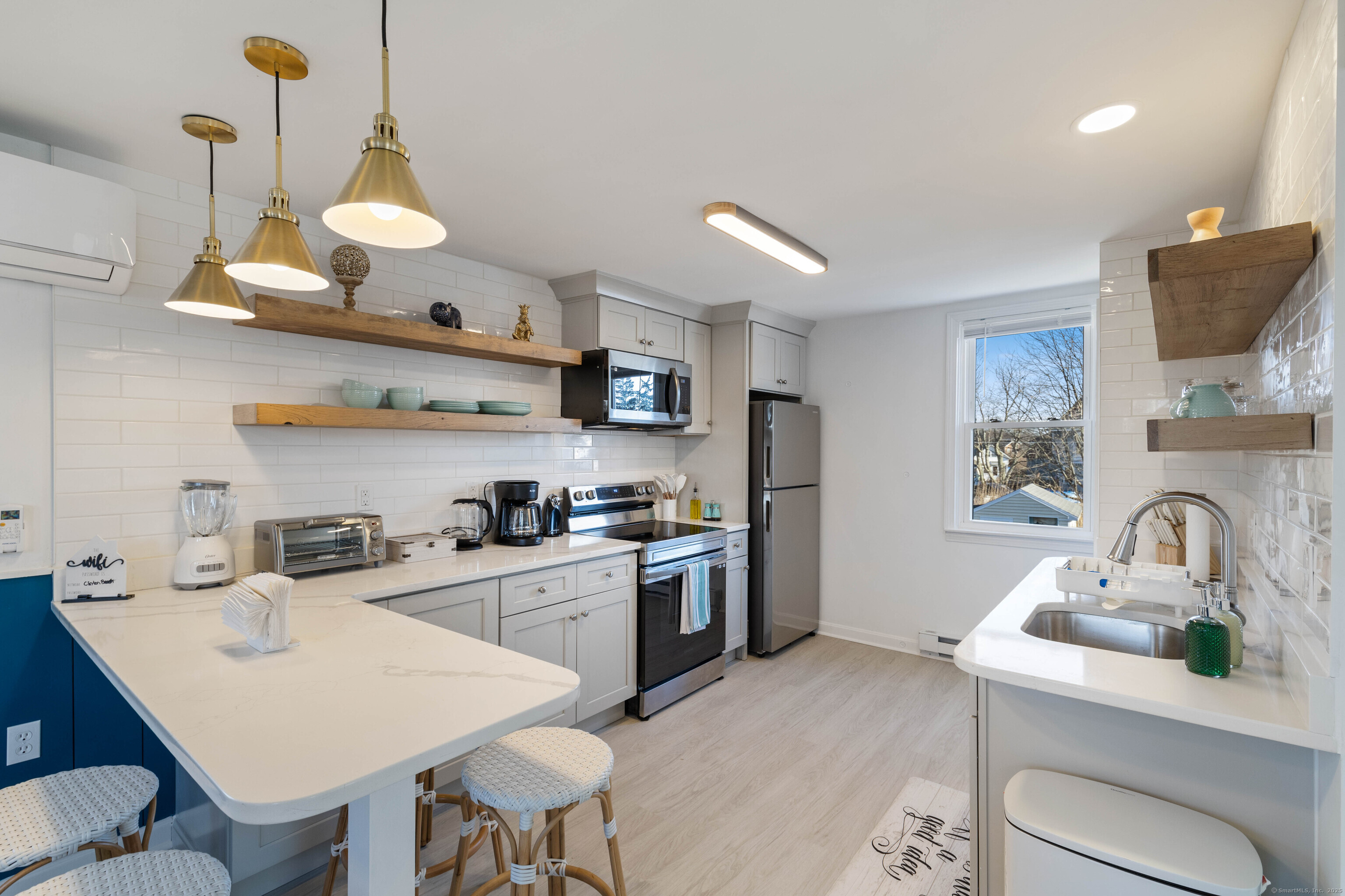 176 Shore Road Clinton, CT 06413 - Photo 12 of 40 a kitchen with a sink a stove and chairs