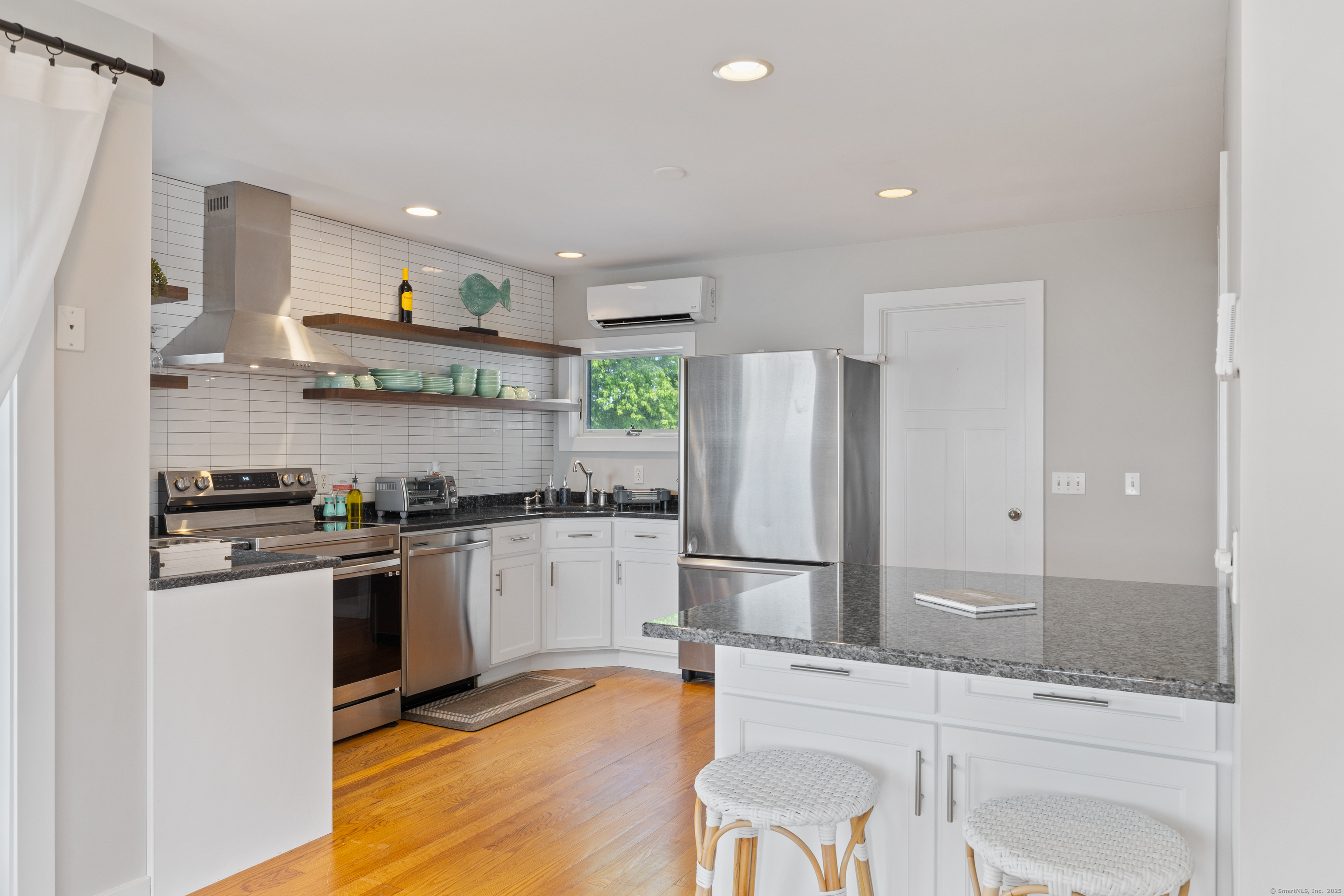 176 Shore Road Clinton, CT 06413 - Photo 25 of 40 a kitchen with stainless steel appliances granite countertop a refrigerator and a stove top oven