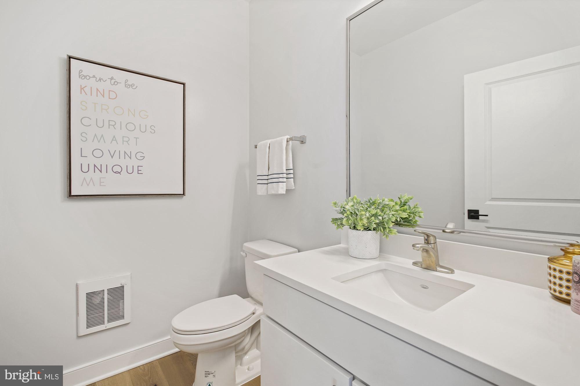 1021 Spring Road Northwest, Unit 1 Washington, DC 20010 - Photo 6 of 27 a bathroom with a sink toilet and a mirror